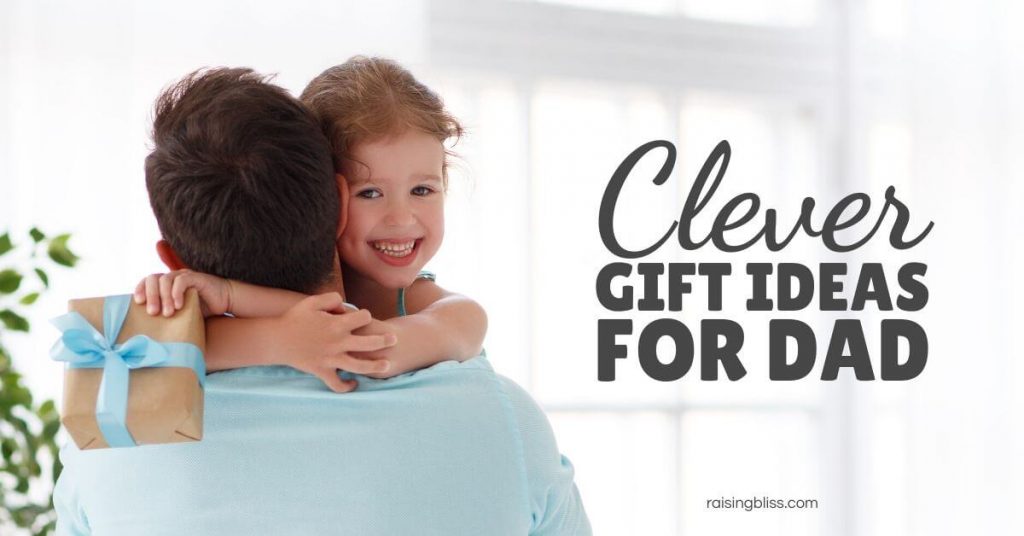 Little girl hugging dad holding a gift