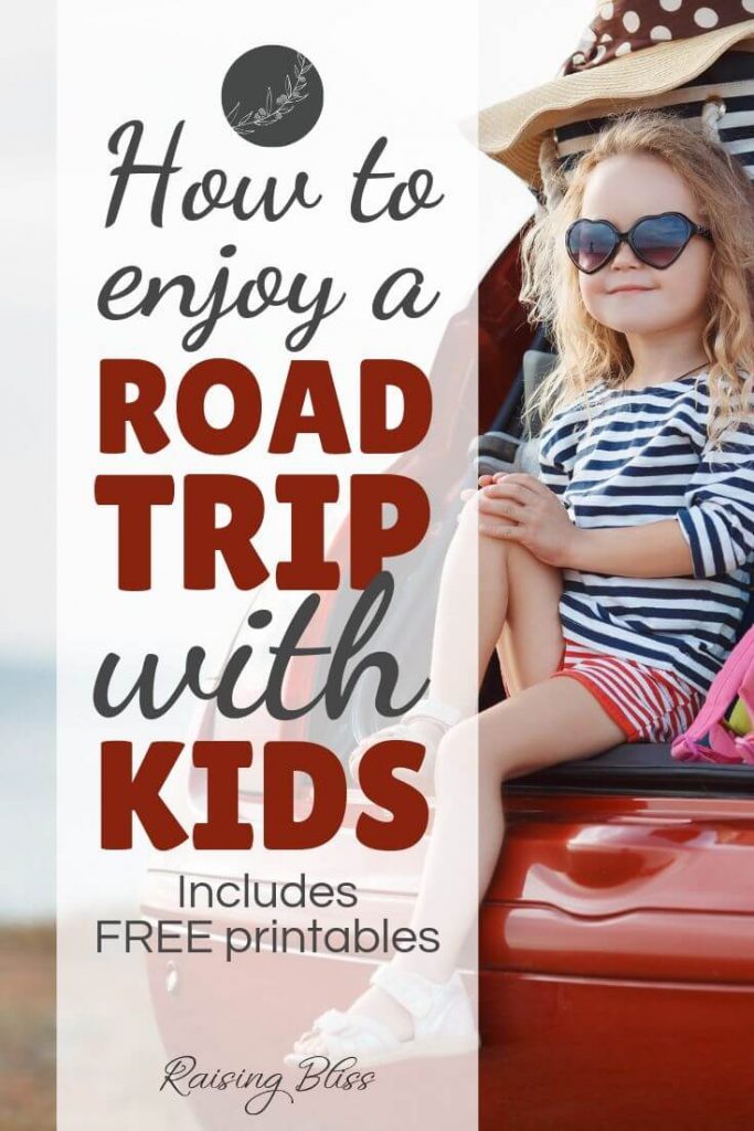 Little girl sitting in the trunk of a car with suitcases. How to enjoy a road trip with kids by raising bliss