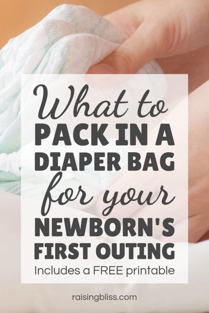 Woman's hands holding diapers What to pack in a diaper bag for your newborn first outing by raising bliss