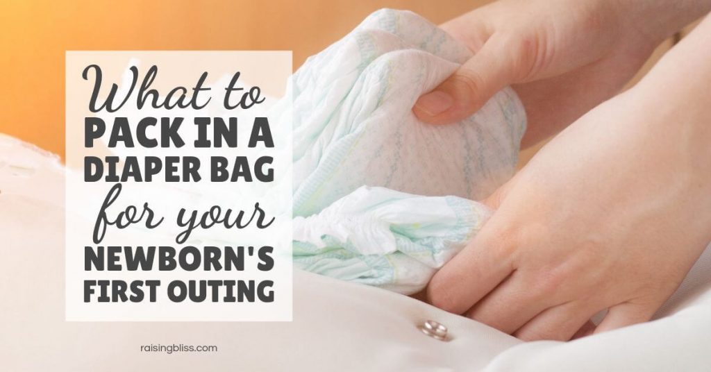 Woman's hands holding diapers What to pack in a diaper bag for your newborn first outing by raising bliss