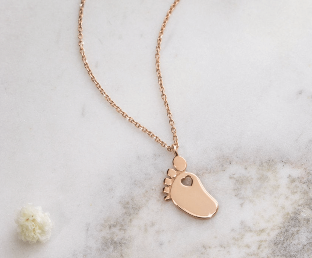 baby foot with heart necklace