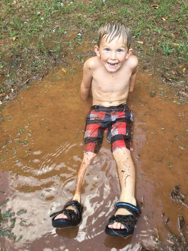 little boy playing in the dirt